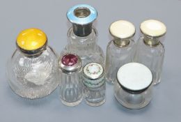 Seven assorted early 20th century silver mounted glass scent bottles including four with enamel,