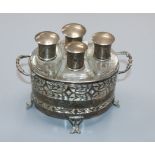 A George V pierced silver two handled scent bottle stand, Birmingham, 1928 with four mounted glass