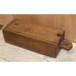 A teak dug-out box, sliding lid L.54cm