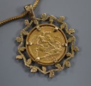 An 1897 gold sovereign in 9ct gold openwork mount on 9ct gold chain, gross 14 grams.