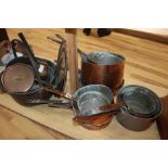 A collection of copper pans, pewter plates etc