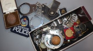 Assorted items including badges, handcuffs and golf memorabilia.