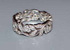 A modern 750 white metal and diamond set pierced foliate ring, size N.