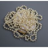 A long single strand cultured pearl necklace, with diamond set yellow metal clasp, 155cm.