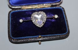 A diamond and moonstone bar brooch, heart-shaped setting in yellow metal (one stone missing),