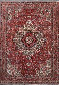 A Bakhtiar Chaleshotor red ground carpet, with central medallion in a field of scrolling foliage and