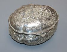 An early 20th century continental repousse silver oval trinket box, decorated with cherubs, import