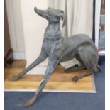 A bronze garden ornament of a seated greyhound