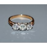 A diamond three-stone ring in yellow metal setting (tests as 18ct) size K.