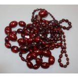 A small group of assorted simulated cherry amber necklaces including facetted.