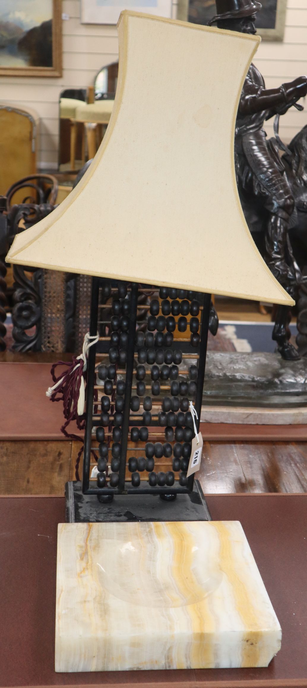 A Chinese abacus, now a lamp and a large onyx ashtray