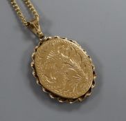 A 9ct gold engraved enclosed locket on 9ct gold chain, gross 14 grams.