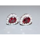 A pair of 18ct white gold, ruby and diamond pear-cut cluster ear studs, 10mm.