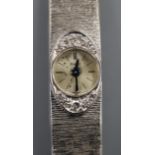 A lady's 750 white metal and diamond set Piaget manual wind bracelet wrist watch, approx. 17cm.