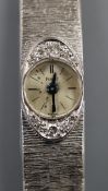 A lady's 750 white metal and diamond set Piaget manual wind bracelet wrist watch, approx. 17cm.