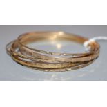 A 9ct gold narrow bangle with engine-turned decoration and seven other narrow bangles.