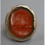 A large 19th century yellow metal and intaglio carnelian set signet ring, carved with the bust of