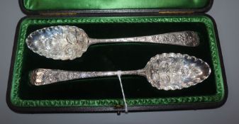 A cased matched pair of later-embossed George III silver berry spoons, London, 1796, one by