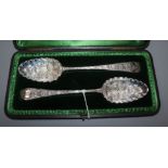 A cased matched pair of later-embossed George III silver berry spoons, London, 1796, one by