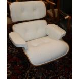 An Eames style lounge chair in white leather