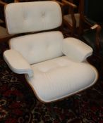 An Eames style lounge chair in white leather