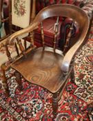 A Victorian elm and beech smokers bow chair