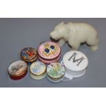 A collection of enamel pill boxes and a soapstone carved bear