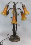 A Tiffany-style lamp lacking one shade