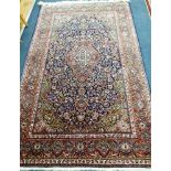 A Kashan red ground rug 212 x 130cm