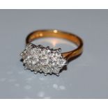 A modern 18ct gold and diamond cluster ring, size M.