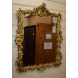 A 19th century rococo-style giltwood and gesso mirror H.65cm