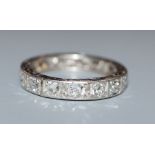 A white metal and diamond set full eternity ring, size alteration, size K/L.