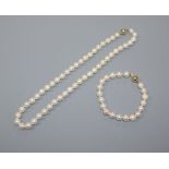 A single row uniform cultured pearl necklace with 18ct gold ball clasp and a similar bracelet with