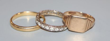 An 18ct yellow gold wedding band, a 9ct gold signet ring and a 9ct white gold and zircon eternity