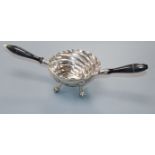 A Continental white metal two handled spiral decorated tasting bowl, on claw and ball feet,