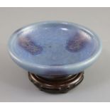 A Chinese Jun type purple-splashed dish, Qing dynasty, unglazed dark brown disc foot, D. 12.5cm,