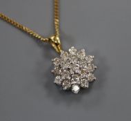 An 18ct gold and diamond cluster pendant, on a 9ct gold chain, pendant overall 18mm.