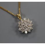 An 18ct gold and diamond cluster pendant, on a 9ct gold chain, pendant overall 18mm.