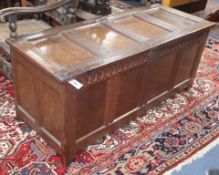 An early 18th century panelled oak coffer, with fluted frieze and moulded stiles, W.140cm