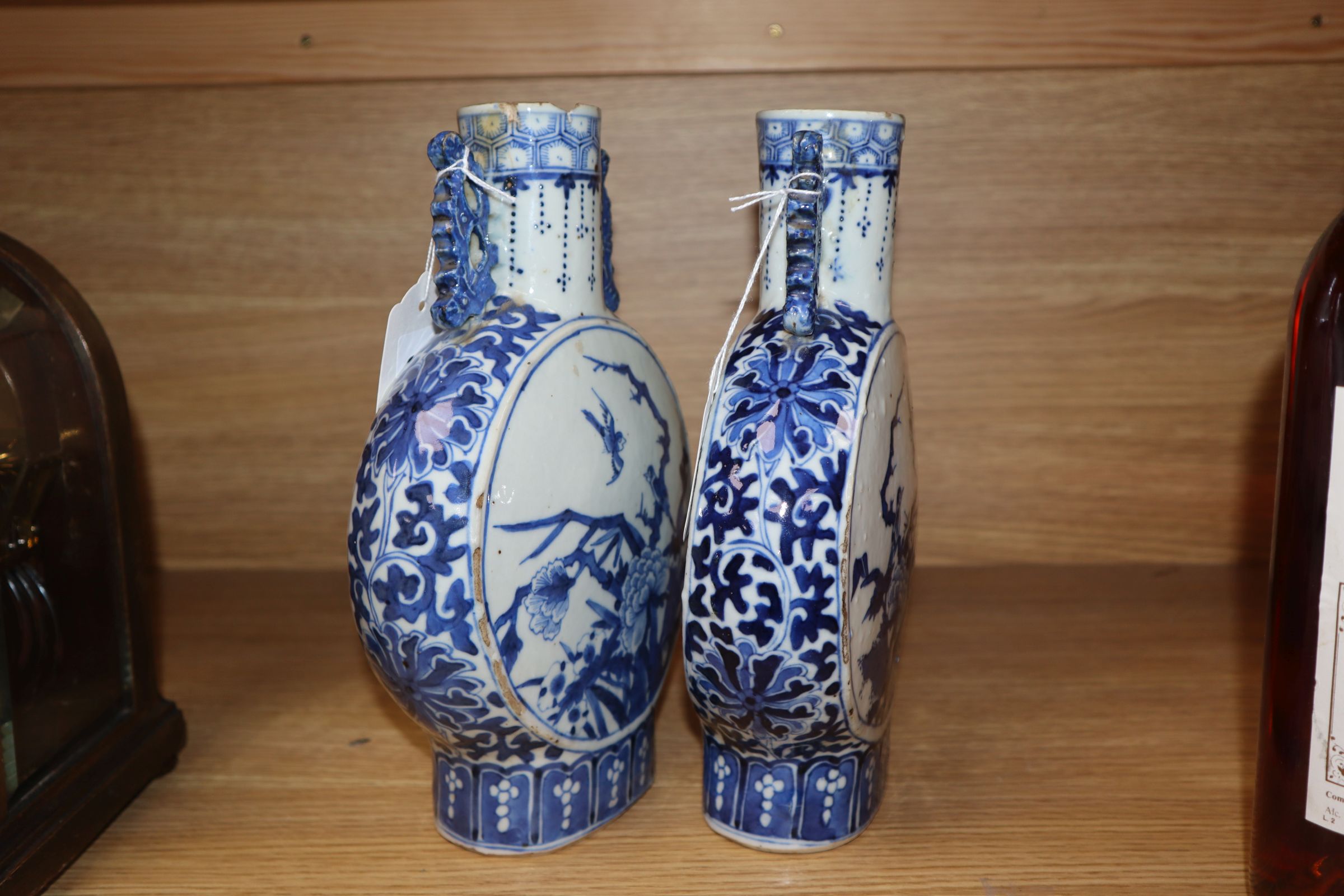 A pair of 19th century Chinese blue and white moon flasks, Kangxi marks, decorated birds and - Image 3 of 11