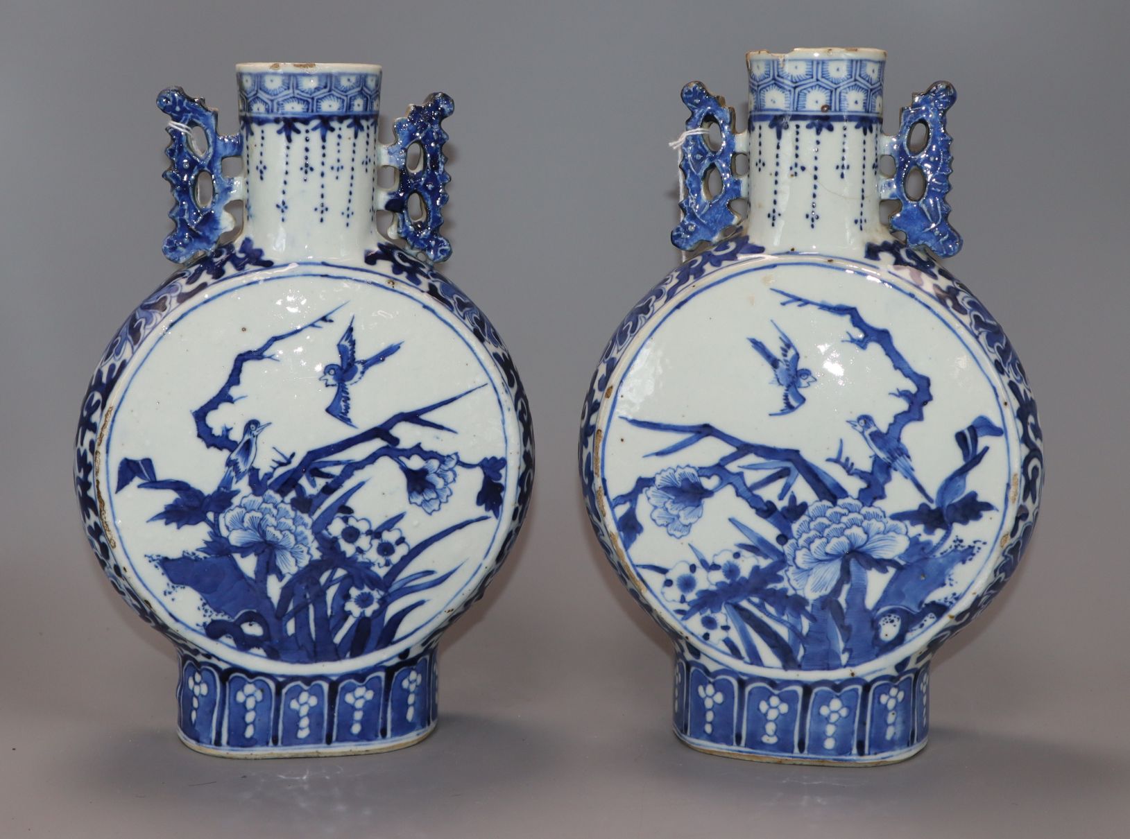 A pair of 19th century Chinese blue and white moon flasks, Kangxi marks, decorated birds and