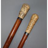 Two pique worked ivory handled canes longest 97cm