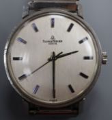 A gentleman's 1970's stainless steel Baume & Mercier manual wind wrist watch, on associated flexible