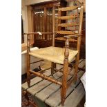 A provincial ladder back elbow chair