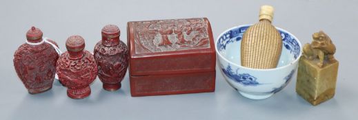 Four Chinese snuff bottles, a cinnabar box, a lion seal and a blue and white tea bowl