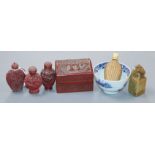 Four Chinese snuff bottles, a cinnabar box, a lion seal and a blue and white tea bowl