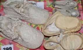 A pair of babies with crochet shoes, pair of leather dolls shoes and a pair of moccasins