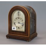 A German chiming mantel clock, with arched glass case height 22.5cm