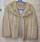 A blonde mink coat, three quarter sleeves, waist length, evening jacket