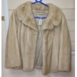 A blonde mink coat, three quarter sleeves, waist length, evening jacket